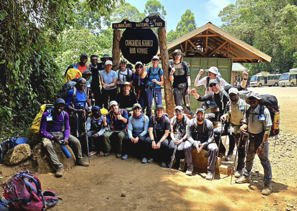 A group of hikers and porters, including Wayland Middle School teachers Kelly Naughton, Brian Reddington and Daniel Fernandez-Davila, pose near the end of the Mount Kilimanjaro hike.  “They said one dream, one team, don't stop till the top,” Fernandez-Davila said. “That's the phrase. Every day they repeated it to you.” 